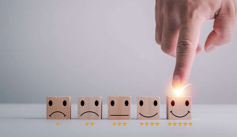 Customer rating with hand choosing five star smiley face