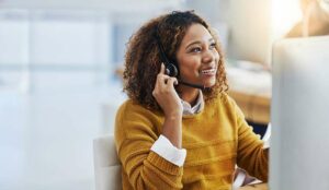 A happy agent working in a call centre.