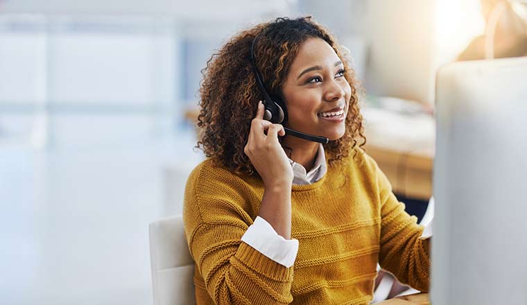 A happy agent working in a call centre.