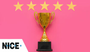 Gold trophy with stars on pink background