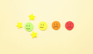 Customer experience concept with rating faces and stars