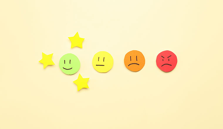 Customer experience concept with rating faces and stars