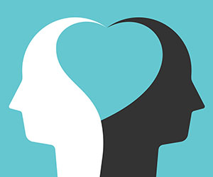 Two white and black head silhouettes united by heart shape inside them - empathy concept