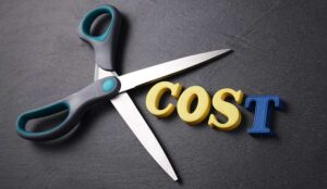 Reducing and cutting cost concept with scissors with the word cost