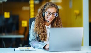 Call center agent with headset working on phones