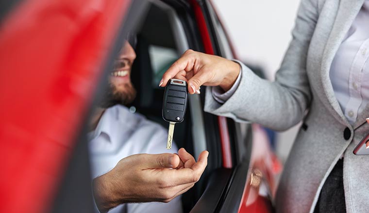 Happy customer getting keys to car