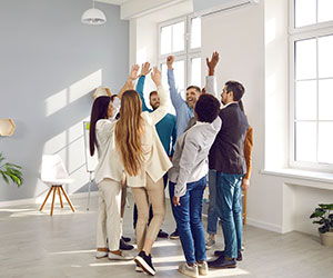 A group of people working together and high fiving