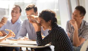 Group of employees laughing and happy at workplace