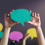 People holding paper speech bubble - greeting and conversation concept