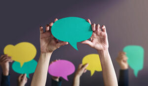 People holding paper speech bubble - greeting and conversation concept