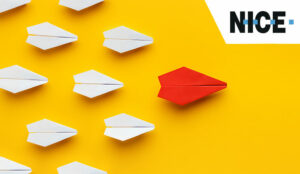 Red paper plane leading others - leadership concept