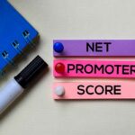 Net Promoter Score - NPS text on sticky notes isolated on office desk