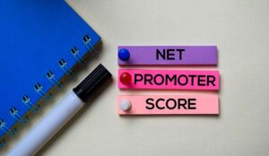 Net Promoter Score - NPS text on sticky notes isolated on office desk