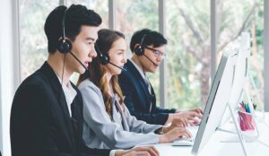 Call centre operators sat at desks in headsets