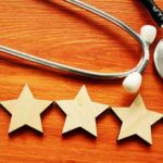 Patient experience and satisfaction concept. Stethoscope and five stars.