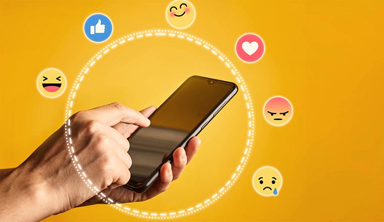 Person holding phone with social icons and emoticons with a circle - frictionless service concept