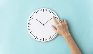 Time concept with hand adjusting clock