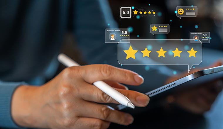 Person holding a tablet with customer reviews and rating stars