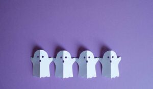 Paper ghosts on purple background