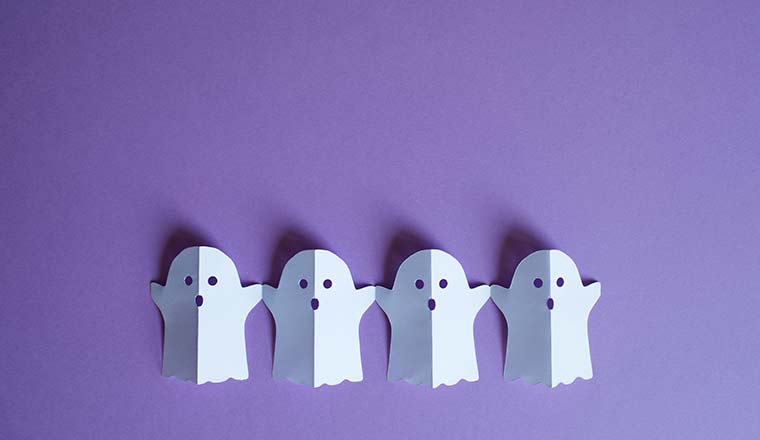 Paper ghosts on purple background