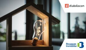 Light bulb with wood house on the table, a symbol for construction, Creative light bulb idea