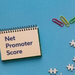 A notebook with the word Net Promoter Score.