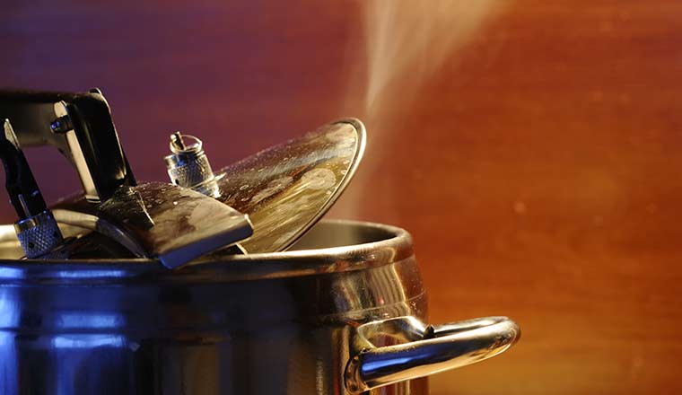 Steam escaping from lid of pressure cooker