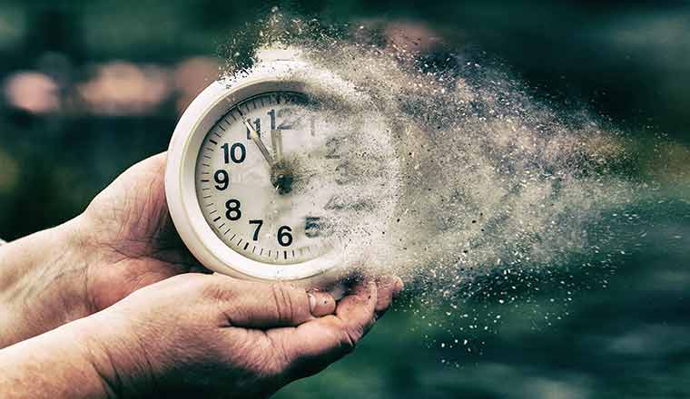 Time concept with person holding fading clock