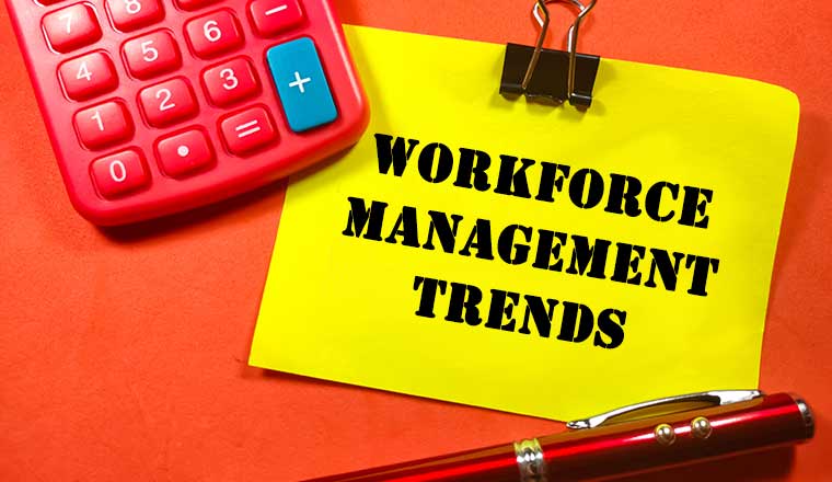 Workforce Management Trends on colorful paper note with calculator and pen on red background.