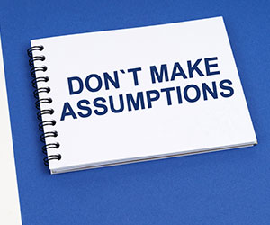 Don't Make Assumptions written on notepad