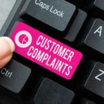 Logging customer complaint concept with the words customer complaints on keyboard