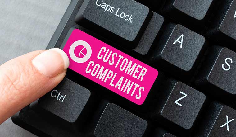 Logging customer complaint concept with the words customer complaints on keyboard