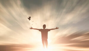 Empowerment concept with person stood by dramatic skyline