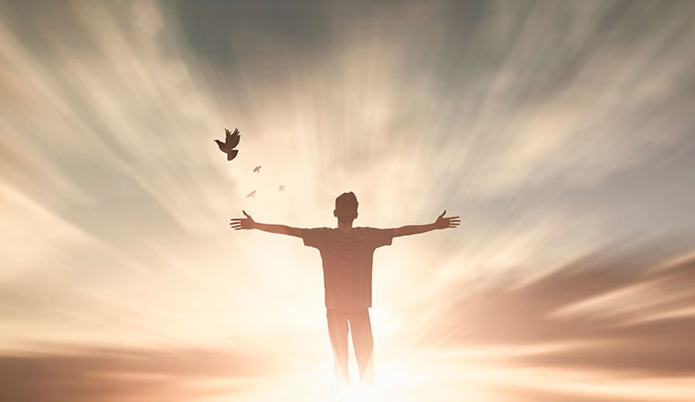 Empowerment concept with person stood by dramatic skyline