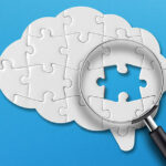 Brain shaped white jigsaw puzzle on blue background. Searching missing piece of the puzzle