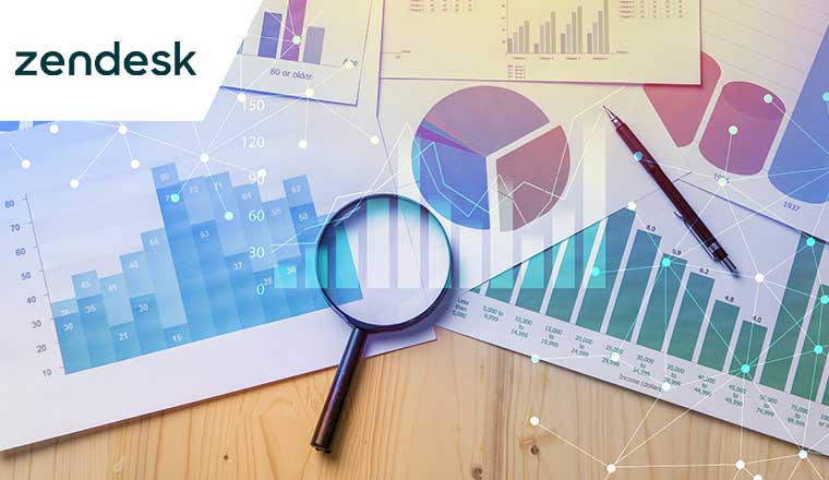 Magnifying glass and documents with analytics data lying on table