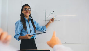 Person giving training pointing at graph on whiteboard