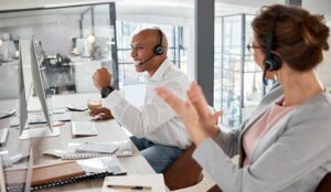 Happy agents celebrating in a call centre