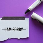 Pen crossed out 'I am Sorry' on note