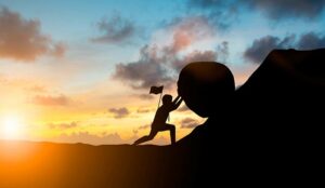 Empowered employee pushing rock up hill