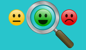 Magnifying glass with positive and negative emoticon