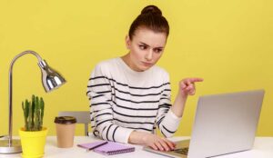 Employee looking annoyed at laptop