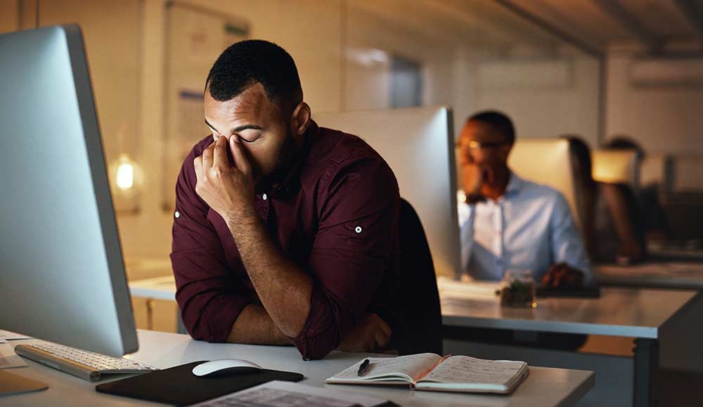 Burnt out employee at desk in office