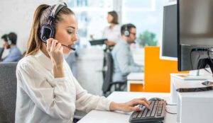 A call center operator working on computer in office