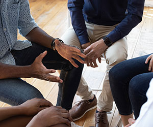 Group of people in a circle having a coaching session