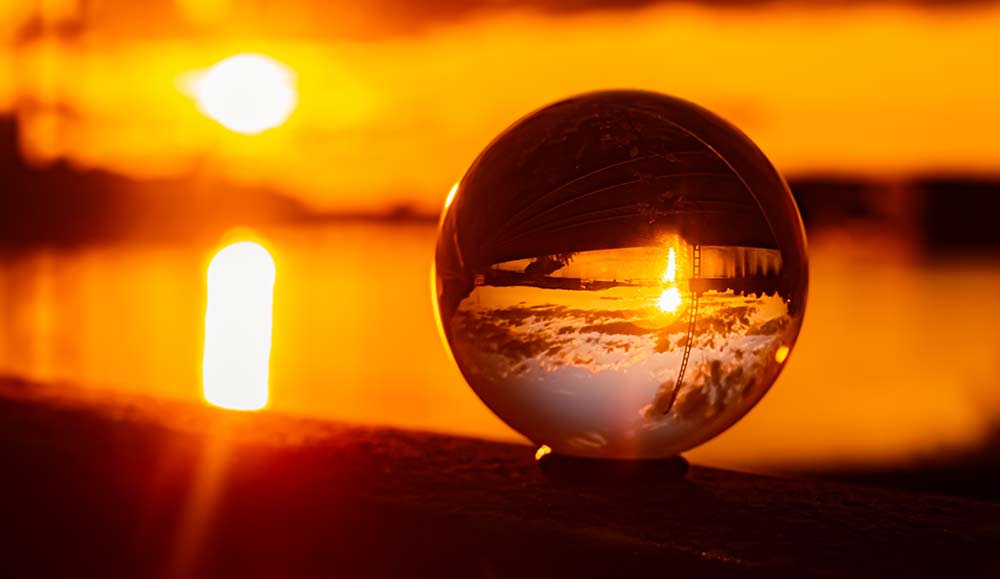 sunset in the background with a crystal sphere