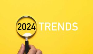 yellow background with the words 2024 trends and a magnifying glass