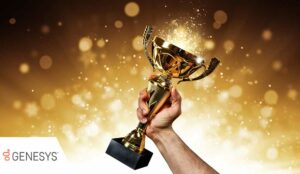 A hand holding up a gold trophy cup with abstract shiny background