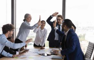 Team of work colleagues high fiving