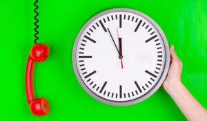 Phone and clock on a green background